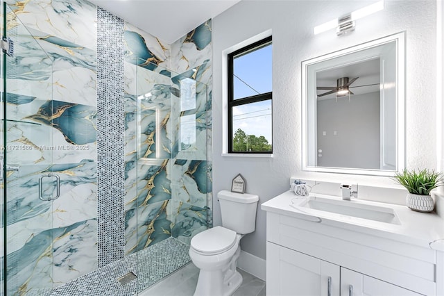 bathroom featuring ceiling fan, a shower with door, vanity, and toilet