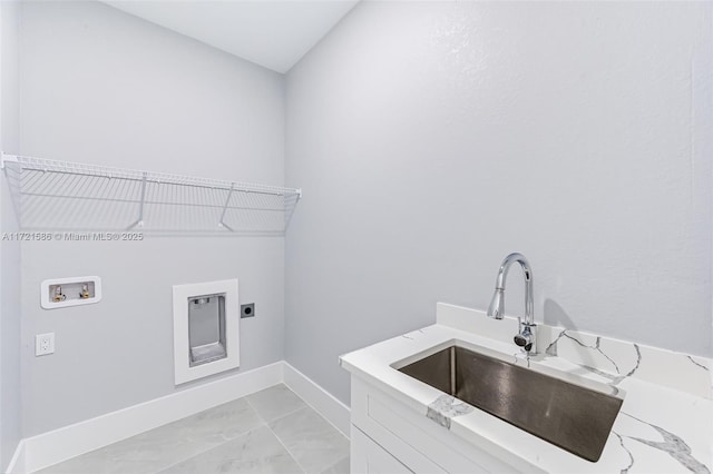 laundry area featuring electric dryer hookup, hookup for a washing machine, sink, and cabinets