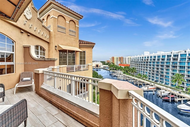 balcony with a water view and a city view