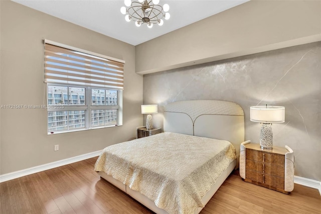 bedroom featuring a chandelier and hardwood / wood-style floors