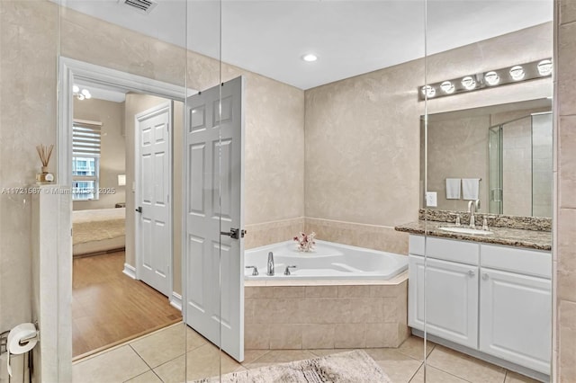 bathroom featuring tile patterned floors, vanity, and independent shower and bath