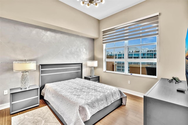 bedroom with baseboards and wood finished floors