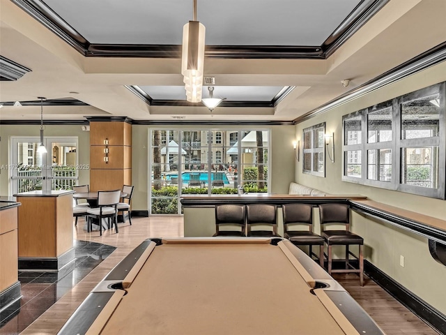 playroom featuring billiards, baseboards, a raised ceiling, dark wood finished floors, and ornamental molding