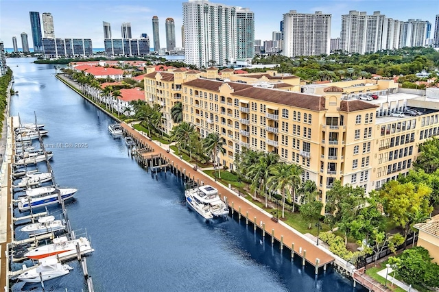 birds eye view of property with a view of city and a water view