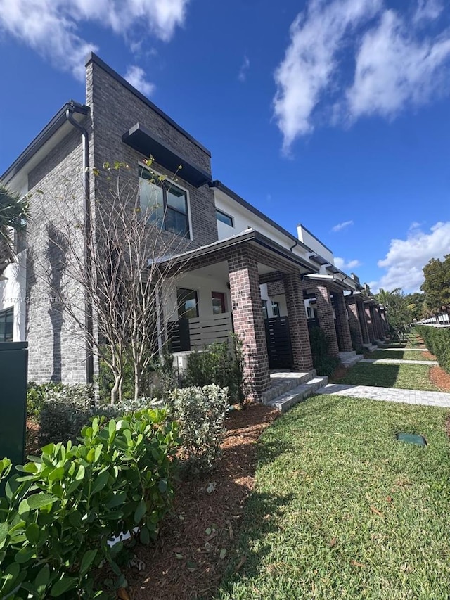 view of side of property with a lawn