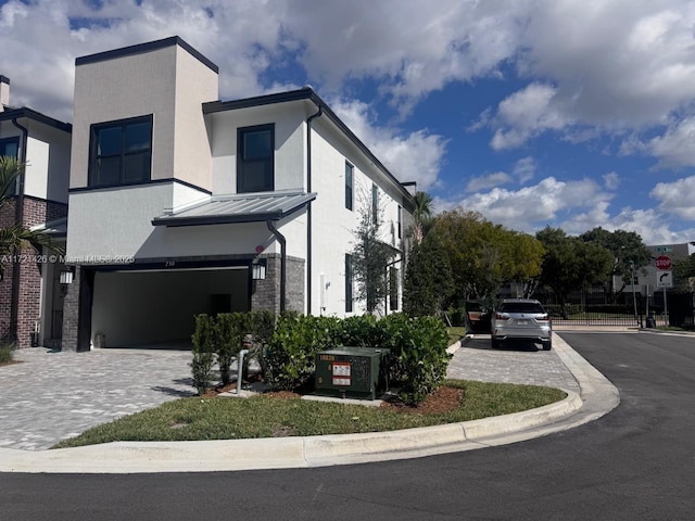 view of front of property with a garage and central AC