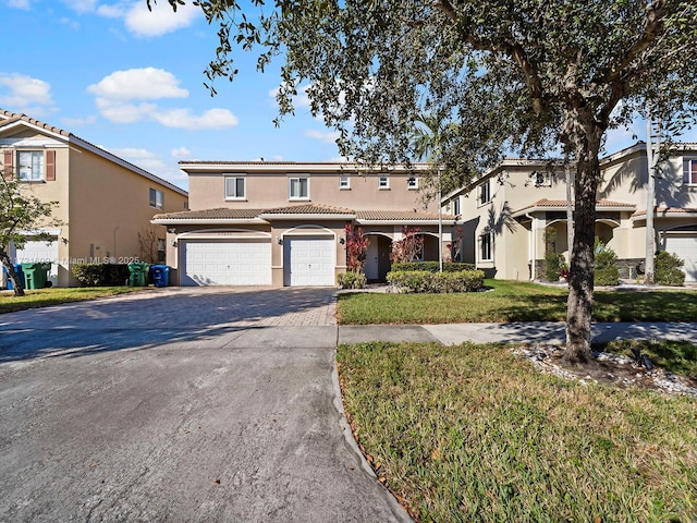 view of front of home featuring a front yard and a garage