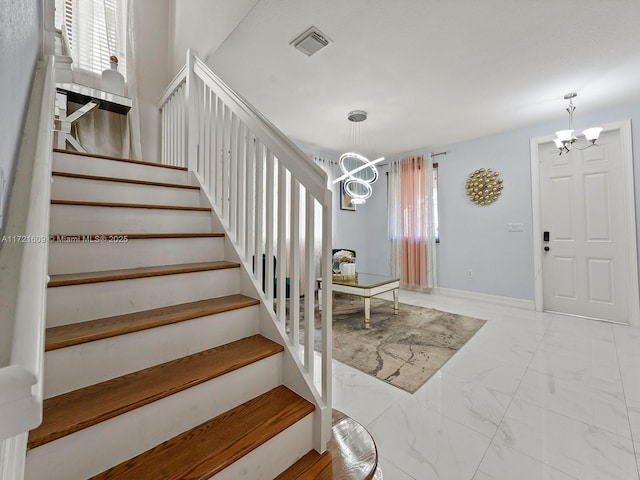 foyer entrance with an inviting chandelier