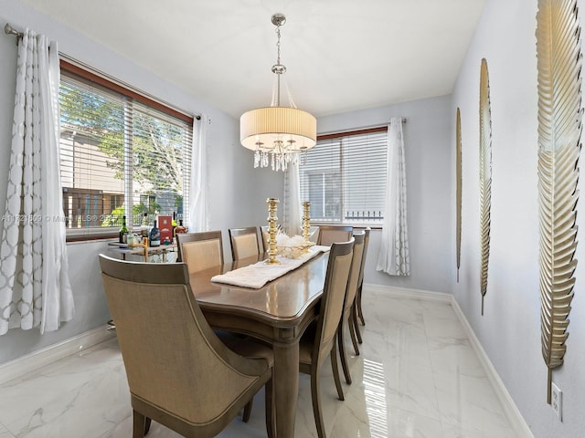 dining area featuring a notable chandelier