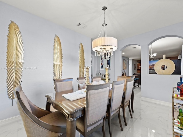 dining space featuring an inviting chandelier