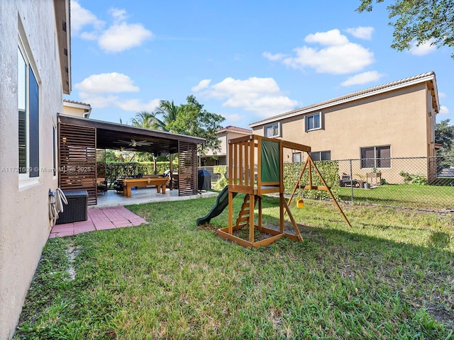 view of playground featuring a patio area, ceiling fan, a yard, and cooling unit