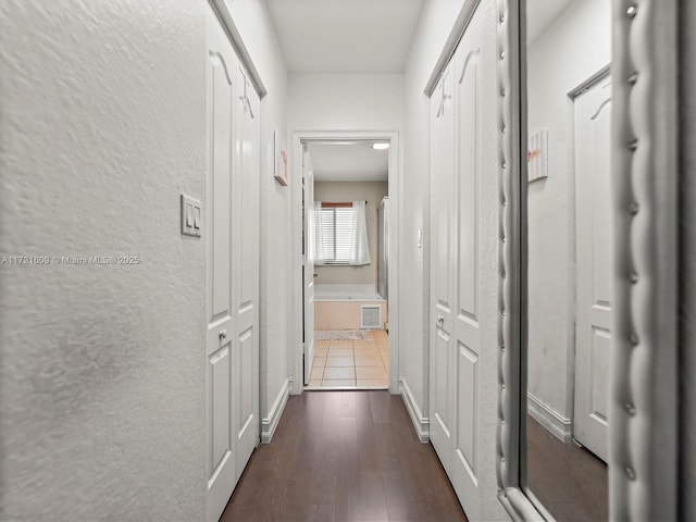 hallway featuring dark hardwood / wood-style flooring