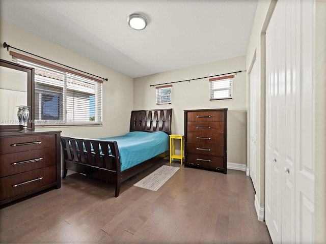 bedroom with a closet and dark hardwood / wood-style floors