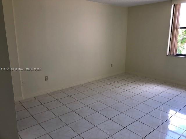 spare room with light tile patterned floors