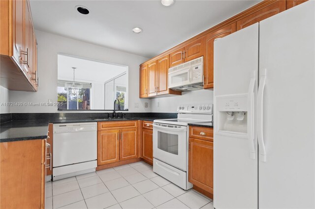 kitchen with pendant lighting, white appliances, sink, a notable chandelier, and light tile patterned flooring