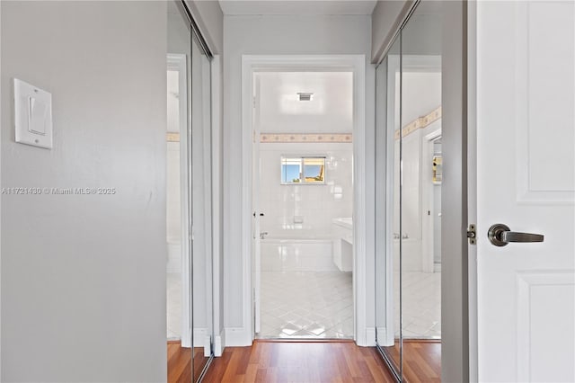 hallway with wood-type flooring