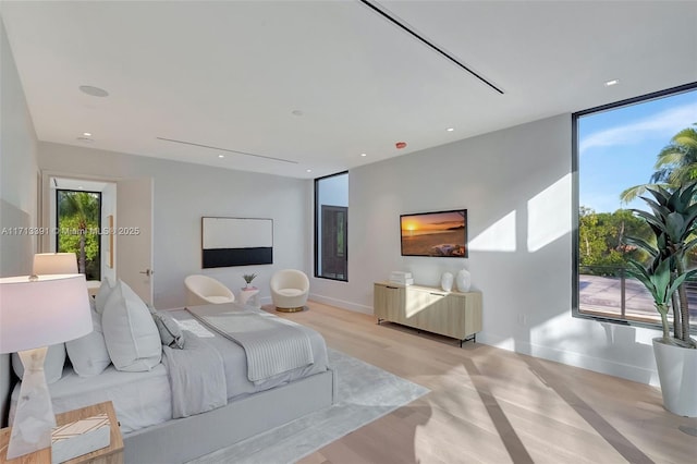 bedroom featuring access to exterior, recessed lighting, and baseboards