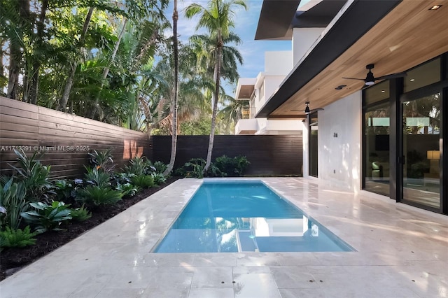 view of pool with ceiling fan, a patio area, a fenced backyard, and a fenced in pool