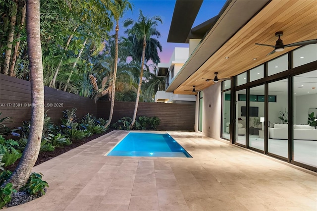 view of pool featuring ceiling fan, a patio area, a fenced backyard, and a fenced in pool