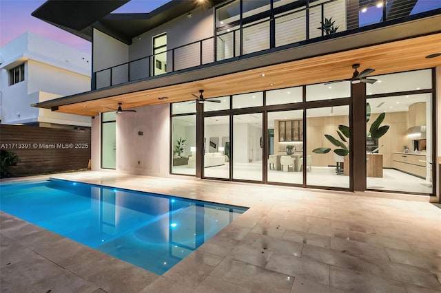 view of pool with a patio area, a fenced in pool, and a ceiling fan