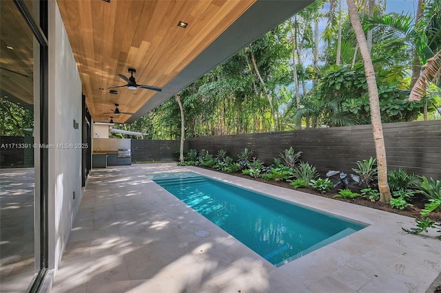 view of swimming pool featuring ceiling fan, a patio, a fenced backyard, and a fenced in pool