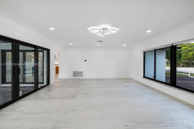 unfurnished room featuring french doors