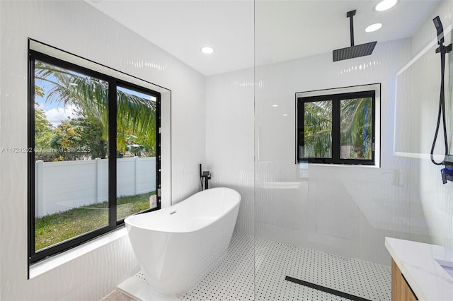 bathroom featuring vanity and plus walk in shower