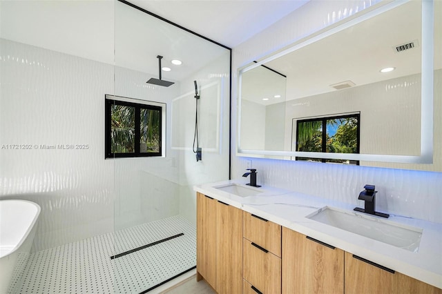 bathroom featuring vanity, independent shower and bath, and backsplash