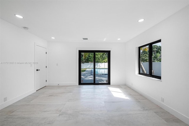 spare room featuring plenty of natural light