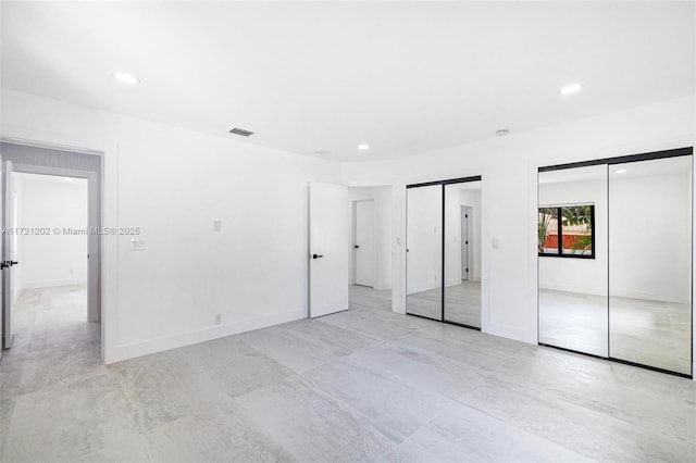 unfurnished bedroom featuring two closets