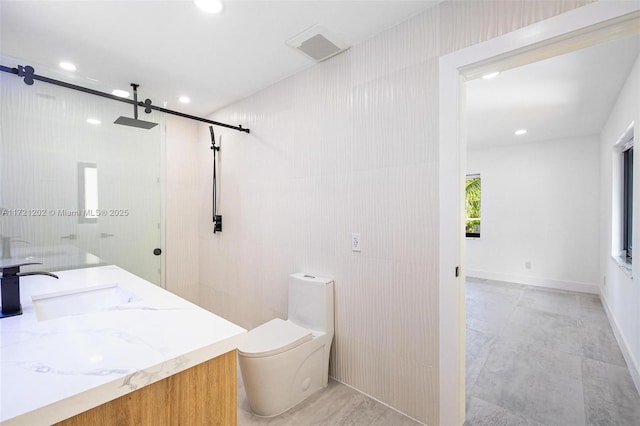 bathroom with a shower with door, vanity, and toilet