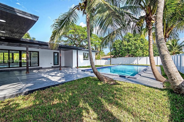 view of pool with a lawn and a patio area