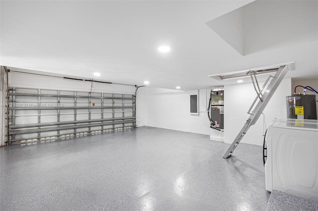 garage featuring heating unit, electric panel, washer / dryer, and water heater