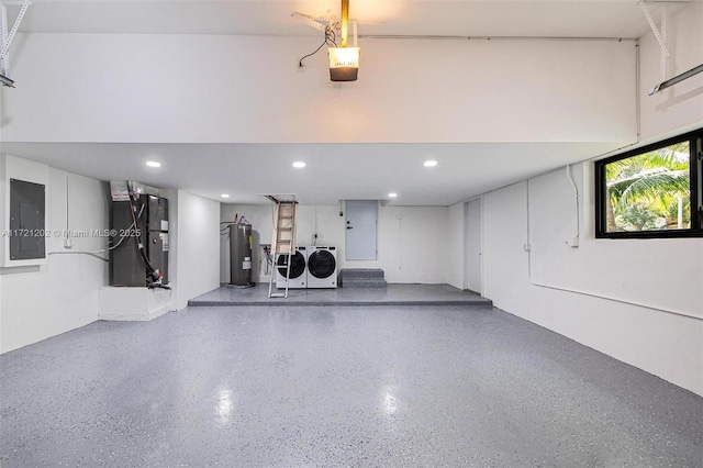 interior space with heating unit, water heater, washing machine and clothes dryer, electric panel, and a garage door opener