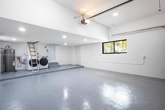 garage featuring washing machine and clothes dryer, a garage door opener, and water heater