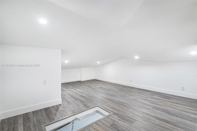 bonus room with lofted ceiling and hardwood / wood-style floors