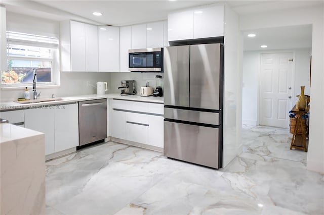 kitchen featuring white cabinetry, sink, and appliances with stainless steel finishes