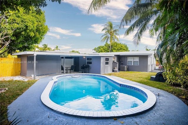 back of property featuring a lawn and central AC unit