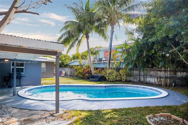 view of pool with a grill