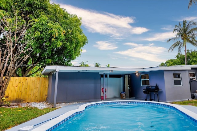 view of pool with a grill