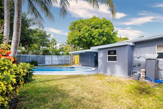 view of pool with a yard