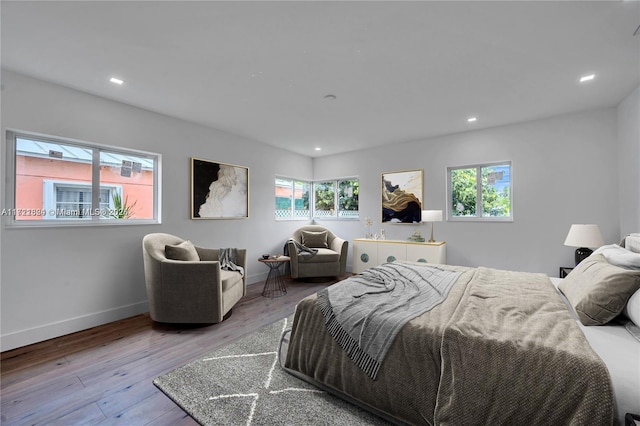 bedroom featuring light wood-type flooring and multiple windows