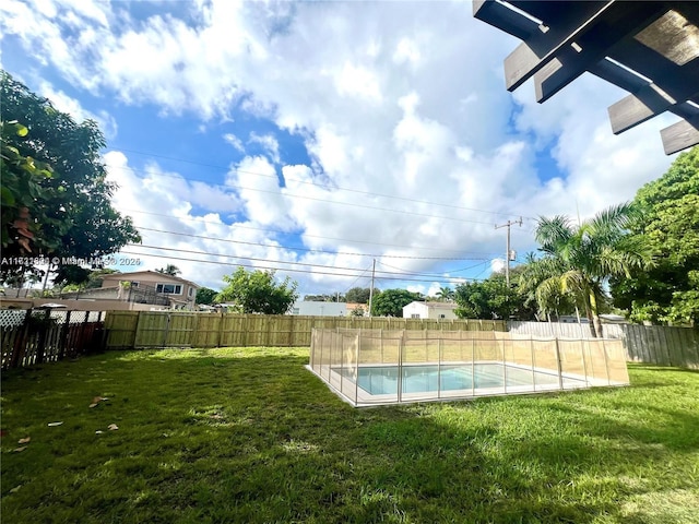 view of pool featuring a yard