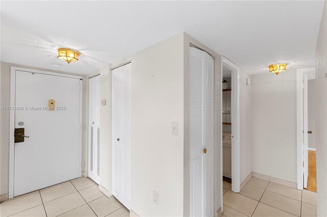 corridor featuring light tile patterned floors