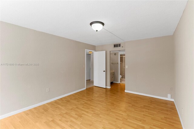 spare room featuring hardwood / wood-style flooring