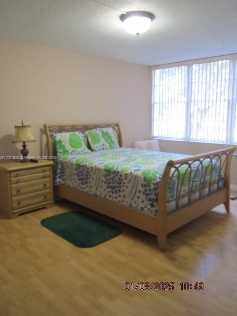 bedroom with hardwood / wood-style floors