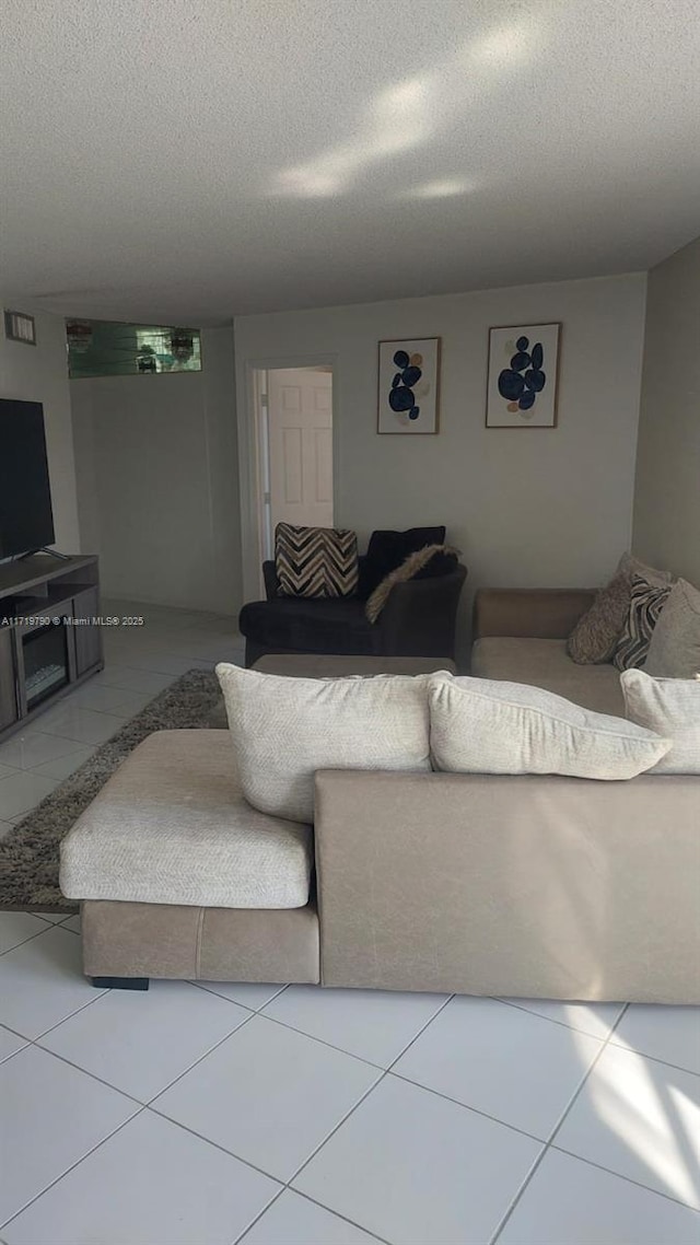 tiled living room with a textured ceiling