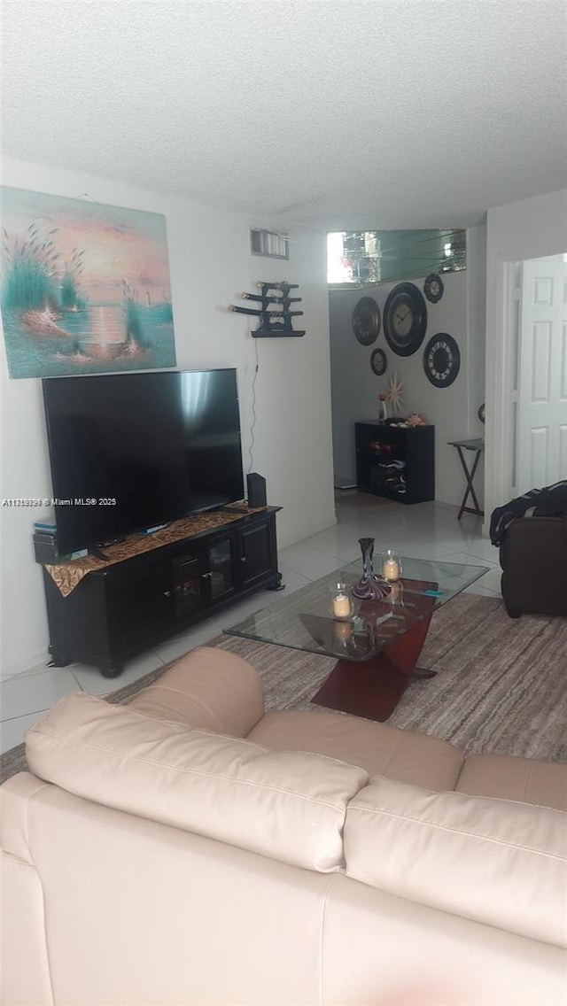 living room featuring tile patterned flooring and a textured ceiling