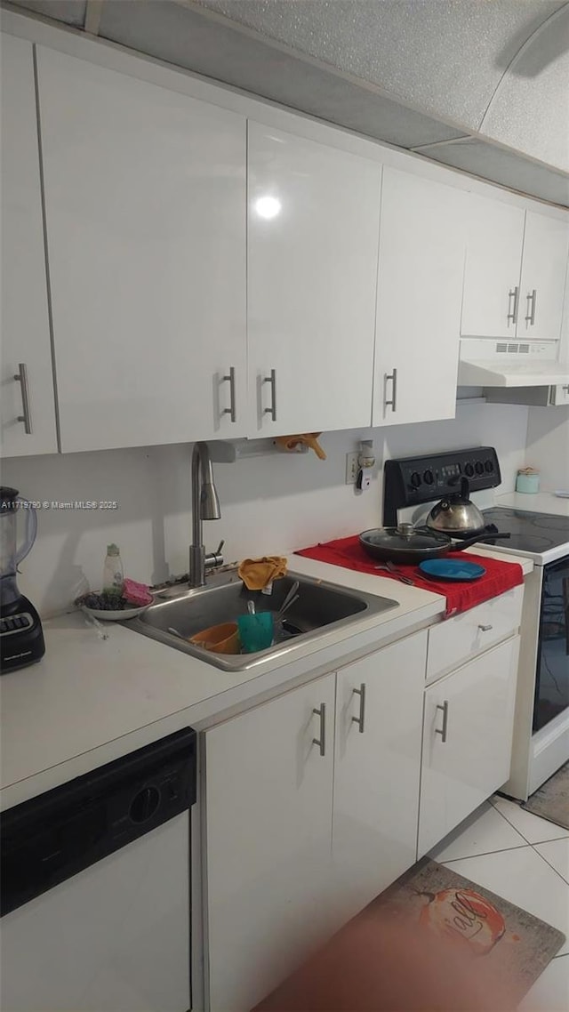 kitchen with white appliances, white cabinetry, and light tile patterned flooring