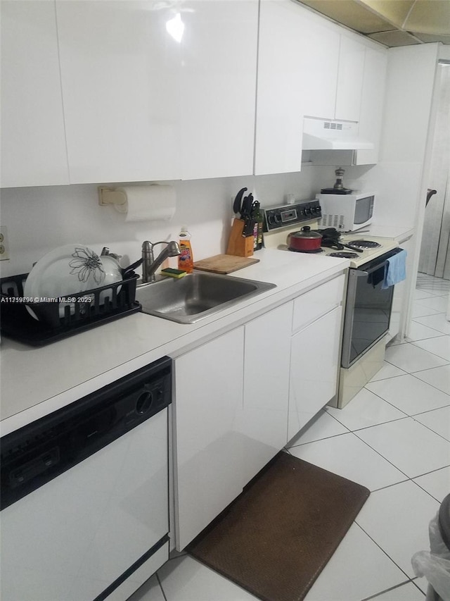 kitchen featuring white cabinetry, white appliances, sink, and light tile patterned floors